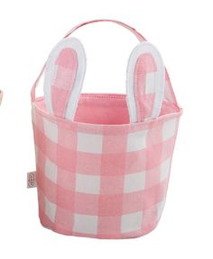 a pink and white checkered basket with an easter bunny in the center, sitting next to it