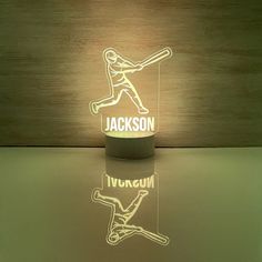 a lamp that has a baseball player on it with the name jackson written in white