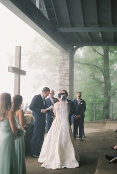 a bride and groom walking down the aisle at their wedding ceremony in front of a group of people