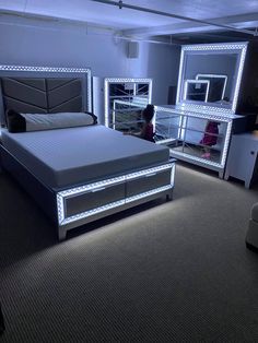 there is a bed that has been made with lights on the headboard and foot board