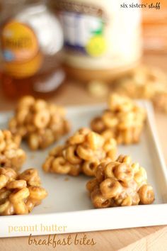 peanut butter pretzels on a white plate with honey in the backgroud