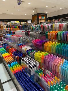 there are many different colors of pens on display in the store, and one is multicolored