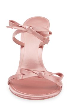 Dainty bows tie around your foot in this svetle sandal lofted by a contemporary flared heel. 3" heel Leather and textile upper/textile lining/synthetic sole Imported