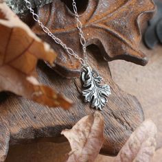 "Hand sculpted fine silver oak leaf pendant. A botanical talisman symbolic of reverence for nature ~ complete with its very own little halo. A wearable idol for every day! The oak is regarded across the world as a symbol of wisdom, strength and endurance. Available on its own or strung from your choice of elegant sterling silver chain or leather cord for a more casual look. This pendant represents a substantial amount of solid fine silver (.999 / 99.9% pure silver) and has a lovely weight and fe Nature-inspired Engraved Sterling Silver Necklace, Nature-inspired Carved Sterling Silver Jewelry, Nature-inspired Pendant Jewelry With Charms, Nature-inspired Pendant Charms Jewelry, Nature-inspired Silver Jewelry With Charms, Nature-inspired Leaf Shape Sterling Silver Jewelry, Nature-inspired Hand Cast Pendant Jewelry, Nature-inspired Carved Pendant Jewelry, Nature-inspired Hand-cast Pendant Jewelry