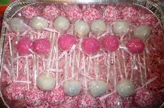 pink and white candies are in a metal pan on the table, ready to be eaten