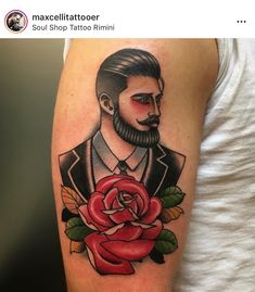 a man with a rose tattoo on his arm