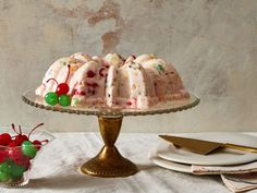 a cake sitting on top of a table next to a plate with fruit toppings