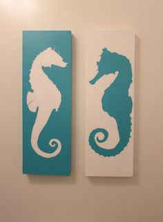 two seahorses are on the wall next to each other in blue and white