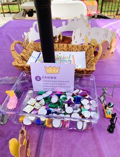 a table topped with lots of candy and candies next to a basket filled with cupcakes