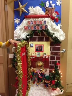 a christmas display with santa's workshop on the top and decorations all around it