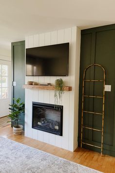 a flat screen tv mounted above a fireplace in a living room