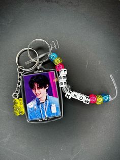 a keychain with a photo and beads on it