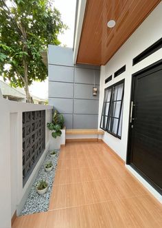 an outdoor area with wood flooring and white walls