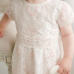 Handmade in the USA A gorgeous Baptism dress for your baby girl, our Elizabeth dress is handcrafted and expertly detailed. It is lined with rich silk Dupioni in an ivory color which enhances the gorgeous embroidered lace that falls over top. The soft pink and ivory embroidered Swiss Dot lace with cording is both comfortable and elegant, and will have everyone believing this is a handmade family dress passed down specially for your little one. Our vintage pink champagne Dupioni silk sash ties all Elegant Fitted Pink Baptism Dress, Cream Pearl Embroidery Dress For Ceremony, White Floral Embroidered Baptism Dress, Pink Lace Dress For First Communion, White Floral Embroidery Baptism Dress, Pink Ceremony Dress With Intricate Embroidery, Lace Baptism Dress With Embroidery For First Communion, Elegant Pink Baptism Dress With Lace Bodice, Fitted Embroidered Lace Baptism Dress