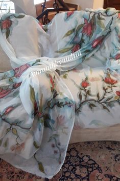 the comforter is covered with an elegant floral pattern and has been draped over it