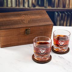 two glasses sitting on top of a table next to a wooden box