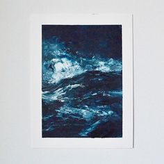 a polaroid photograph of a wave in the ocean with blue water and white foam