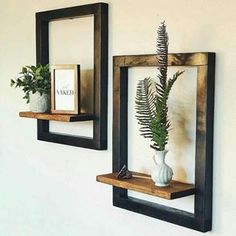 there are two wooden shelves with plants in them on the wall next to each other