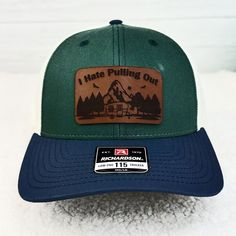 Embrace the great outdoors with this great completed cap!  High quality Richardson brand low profile trucker cap in spruce green and navy. Features a pre-curved visor, cotton sweatband, and is fully adjustable.  This hat comes completed with a TAN 100% leather "I Hate Pulling Out" patch.  Patch measures 2.5" wide. Outdoor Flat Bill Hats For Baseball Season, Flat Bill Hats For Baseball Season, Adjustable Hats For Baseball Season, Curved Brim Trucker Hat For Baseball Season, Snapback Hat For Baseball Season Outdoor Activities, Brown Trucker Hat For Camping, Outdoor Fitted Hat For Baseball Season, Trucker Baseball Cap With Flat Bill For Outdoor Activities, Trucker Baseball Cap With Flat Bill For Outdoor