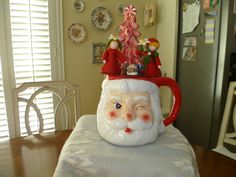 a santa clause mug sitting on top of a table