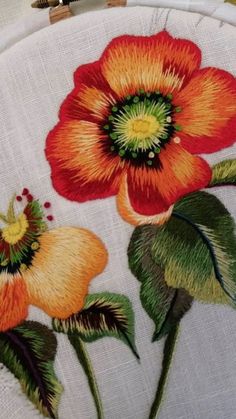 a close up of a flower on a piece of cloth