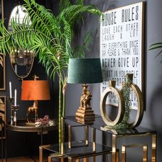 a living room filled with furniture and a green lamp on top of a glass table