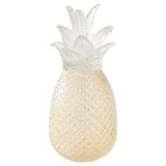 a glass vase with a pineapple on the top is shown in front of a white background