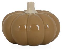 a brown ceramic pumpkin sitting on top of a table