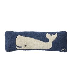 a blue and white pillow with a whale design on the front, it's made out of wool