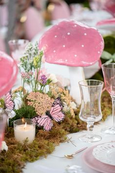 the table is set with pink and white decorations