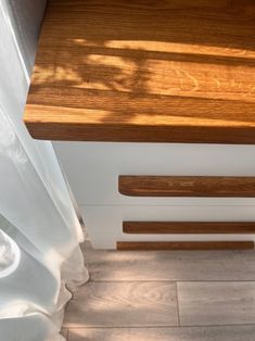 a close up of a wooden bench on a tile floor