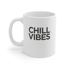 a white coffee mug with the words chill vibes printed on it in black ink