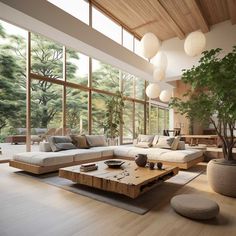 a living room filled with lots of furniture and large windows overlooking the trees in the forest