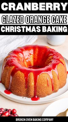 a bundt cake on a white plate with cranberry glaze and christmas baking