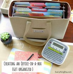 an office - in - a - box is organized with lots of folders and a calculator