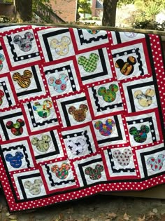 a quilt made to look like mickey and minnie mouse heads on red and white squares