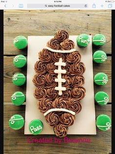 a football cookie with chocolate frosting and green candies