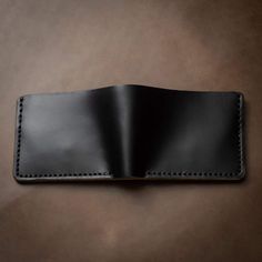 Ever have a leather wallet you can't stop talking about?You will know the difference our craftsmanship makes as soon as you hold this wallet. Our classic design meets attention to detail unparalleled by any department store wallet. Flawless hand-stitching, authentic real leather smell, and backed by a lifetime guarantee. Take satisfaction in knowing that this wallet will be the last one you will ever buy.Full-grain Horween leather means your wallet will develop character and patina. We hand-sew Black Leather Trifold Card Holder, Black Leather Trifold Wallet For Everyday, Black Leather Rectangular Wallet, Black Leather Wallet With Rfid Blocking, Everyday Carry Leather Card Holder With Smooth Grain, Black Leather Wallet For Daily Use, Black Leather Bifold Wallet, Black Smooth Grain Wallet As Gift, Classic Black Bifold Wallet