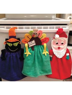 three handmade thanksgiving turkeys hanging on the back of a stove top oven door