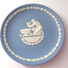 a blue and white plate with an emblem on it