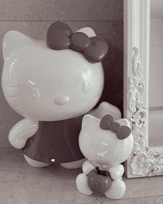 a hello kitty figurine next to a mirror