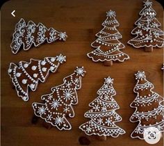 christmas cookies decorated with white icing on a wooden table