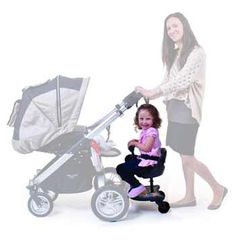 a woman pushing a stroller with a baby in it