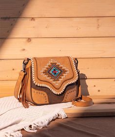 Discover the Montana West Aztec Fringe Crossbody Purse, a stylish Western bag perfect for any occasion. Featuring intricate Aztec embroidery and fringe detailing, this shoulder bag offers a spacious interior and high-quality materials. Ideal for daily use or special events, this purse embodies Western charm and functionality. Brown Embroidered Crossbody Shoulder Bag, Embroidered Brown Crossbody Shoulder Bag, Aztec Embroidery, Fringe Crossbody Purse, Western Bag, Front Fringe, Fringe Crossbody Bag, Western Purses, Aztec Pattern