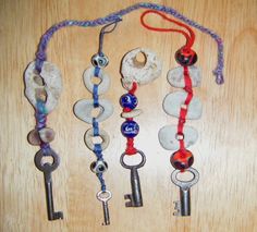 several different types of beads and keys attached to each other on a wooden table top