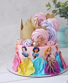 there is a cake decorated with princesses on it