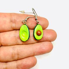 Get ready to swoon over these cute and charming earrings shaped like avocados! Handmade with care by skilled artisans, these clay beauties are out of this world. They're sure to turn heads and add a touch of chic to your outfit. These Mexican earrings offer a mix of traditional and modern styles, perfect for those looking for something one-of-a-kind. Get your hands on some CLAYWELRY™ and experience the joy of wearing something truly special. MATERIAL(S): All our earrings are created using natura Adventure Time Clay Earrings, Unique Green Teardrop Earrings For Gift, Novelty Hypoallergenic Polymer Clay Jewelry, Novelty Polymer Clay Dangle Jewelry, Novelty Nickel-free Polymer Clay Jewelry, Handmade Green Clay Jewelry, Green Novelty Resin Jewelry, Adjustable Novelty Single Earring Jewelry, Green Novelty Dangle Jewelry