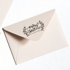 an envelope with a merry christmas sticker on it