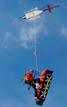 a man is parachuting in the sky with an airplane above him and another person below him