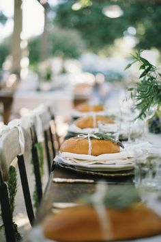 the table is set with bread and wine glasses for an elegant dinner or party event